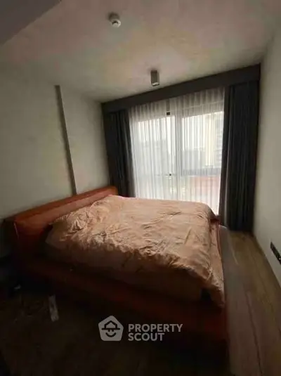 Cozy bedroom with large window and elegant curtains