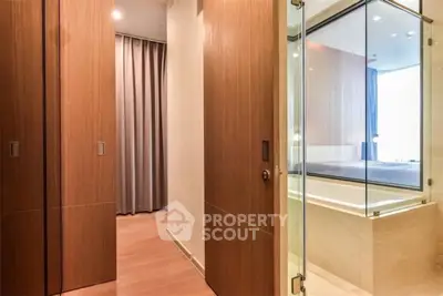 Modern bathroom with glass shower and wooden accents