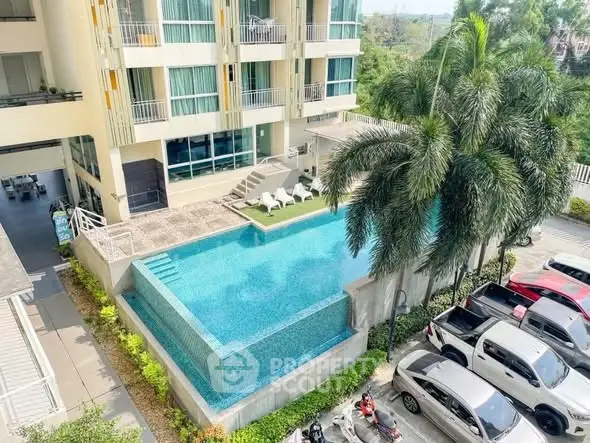 Luxurious apartment building with stunning infinity pool and lush palm trees, perfect for modern living.
