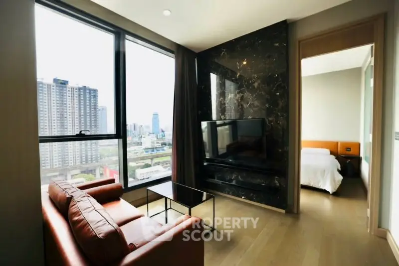 Modern living room with city view and adjacent bedroom in luxury apartment