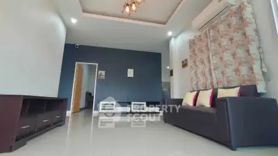 Spacious living room with modern decor and air conditioning