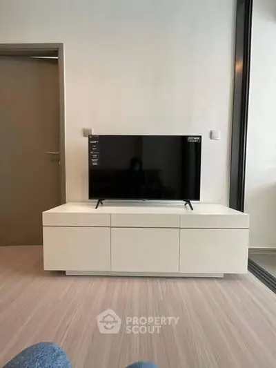 Modern living room with sleek TV stand and flat-screen television