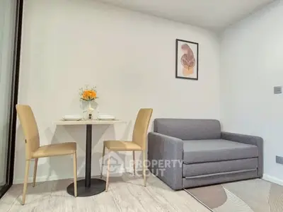 Cozy modern living room with compact dining area and stylish decor