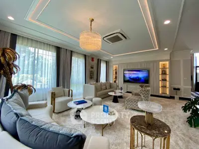 Luxurious living room with elegant decor, plush seating, and large windows offering natural light.