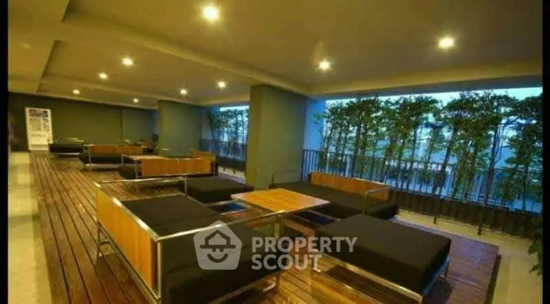Luxurious modern building lobby with stylish seating and ambient lighting.