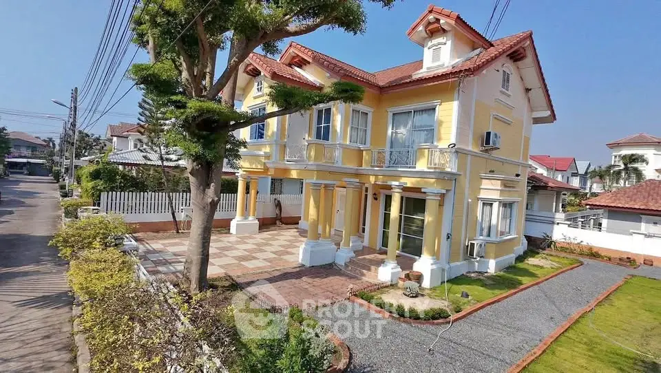Charming yellow two-story house with red roof, spacious driveway, and lush garden in a serene neighborhood.