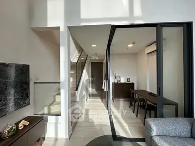 Modern duplex interior with sleek design and natural light