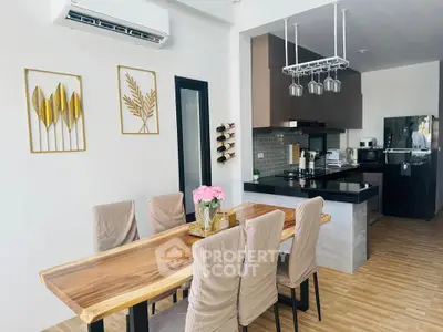 Modern dining area with stylish wooden table and sleek kitchen design