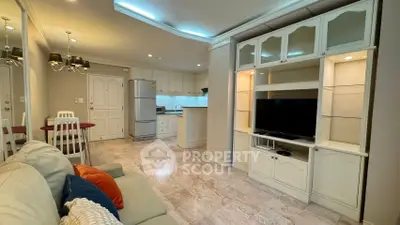 Spacious living room with modern kitchen and elegant furnishings in open layout apartment.
