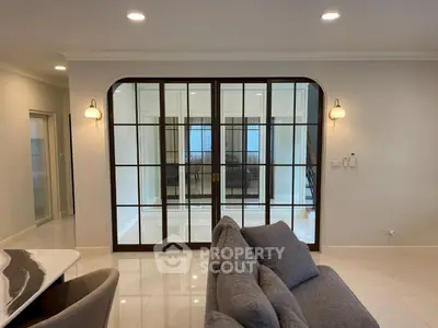 Elegant living room with modern glass doors and stylish furniture