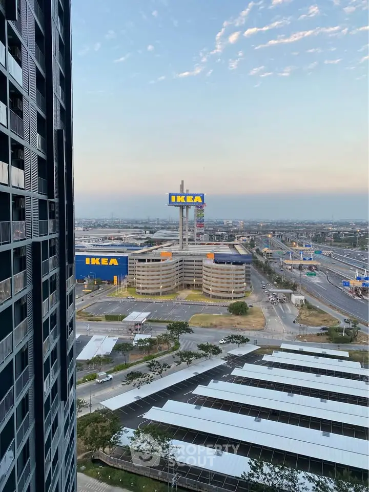 Stunning urban view from high-rise building overlooking IKEA and highway.