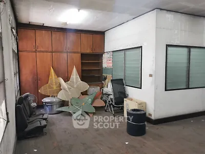 Spacious storage room with wooden cabinets and ample natural light, ideal for organization and utility.