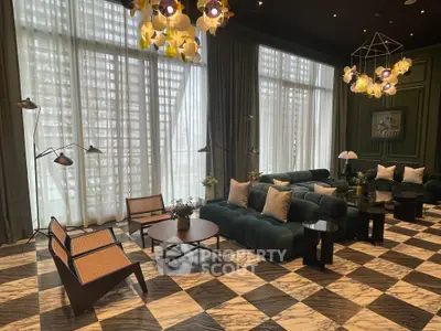 Luxurious living room with modern decor and large windows in upscale property