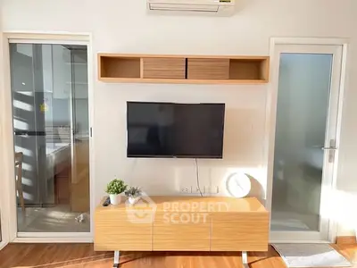 Modern living room with wall-mounted TV and wooden cabinet