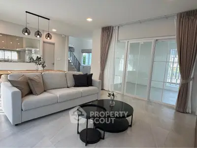 Modern living room with elegant decor and open kitchen layout