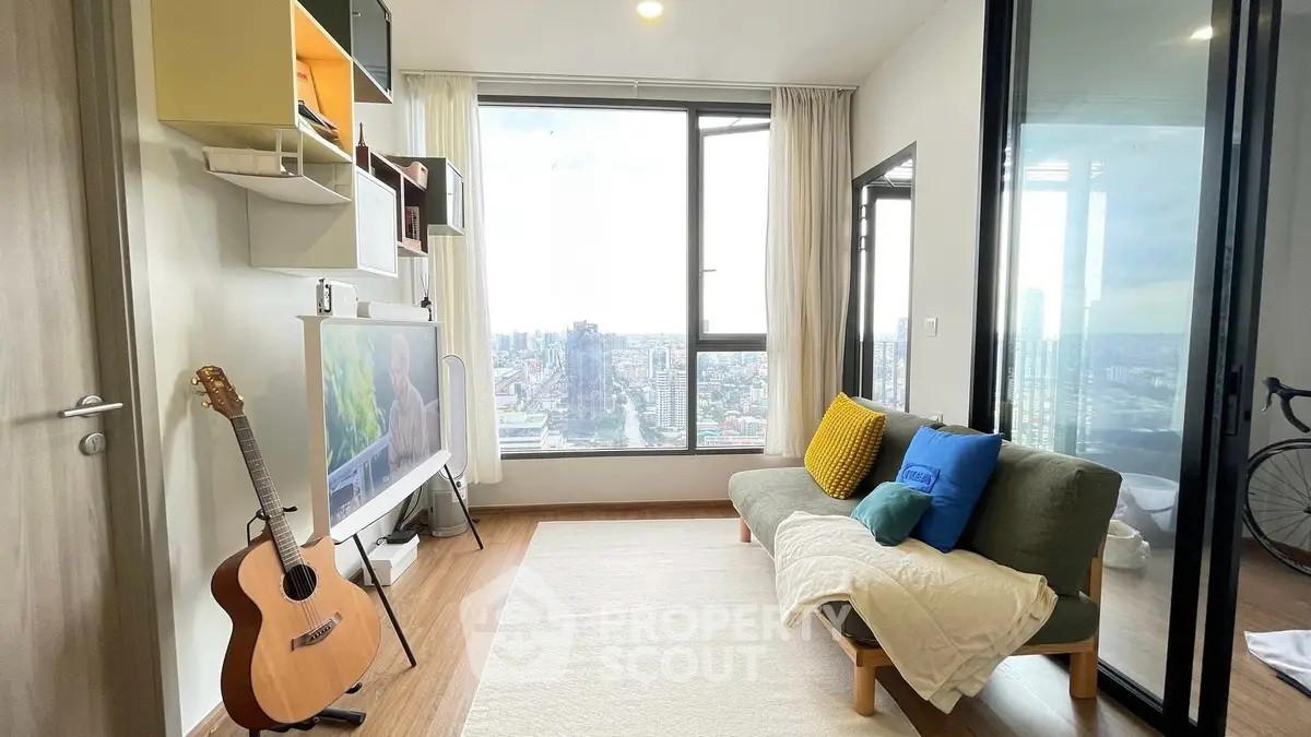 Modern living room with city view, stylish decor, and natural light.