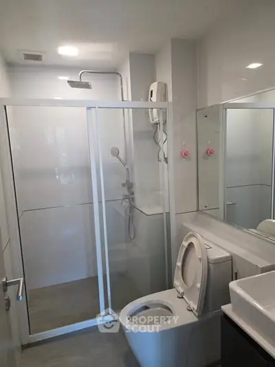 Modern bathroom with glass shower and sleek fixtures