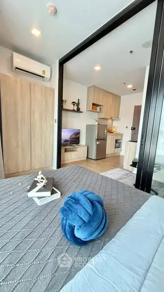 Modern studio apartment with open layout, featuring cozy living area and stylish kitchen.