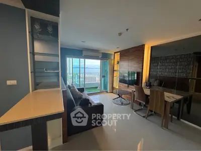 Modern living room with balcony and stunning sea view in a high-rise apartment