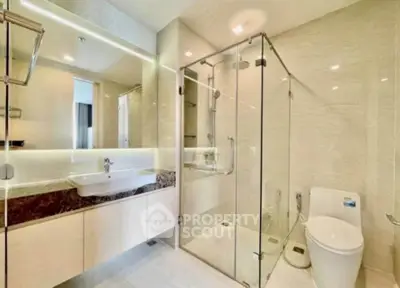 Luxurious modern bathroom with glass shower and elegant fixtures