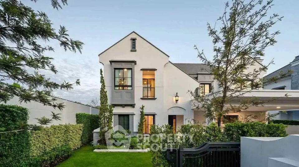 Elegant two-story home with manicured garden and modern architecture