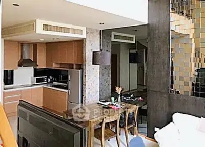 Modern open-plan kitchen and dining area with stylish decor and ample natural light.