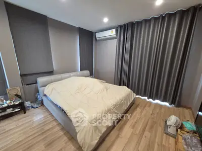 Spacious bedroom with modern decor and ample natural light