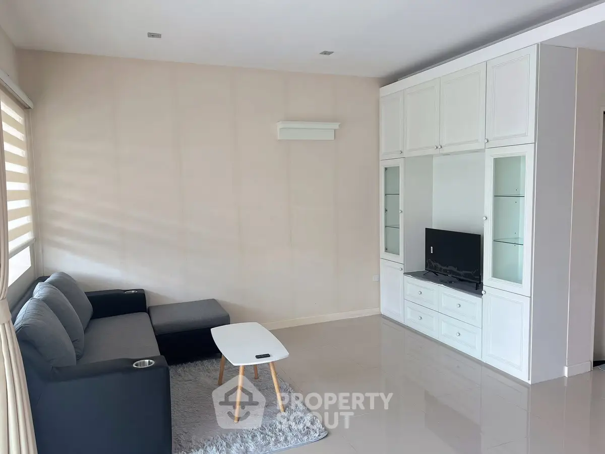 Modern living room with sleek furniture and built-in storage unit, perfect for stylish urban living.