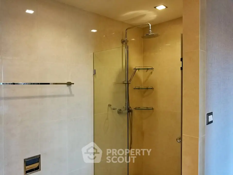 Modern bathroom with glass shower enclosure and sleek fixtures