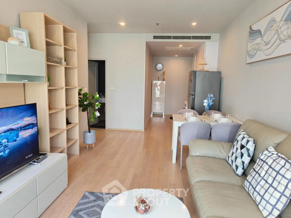 Modern living room with stylish decor and open layout, featuring a cozy seating area and dining space.