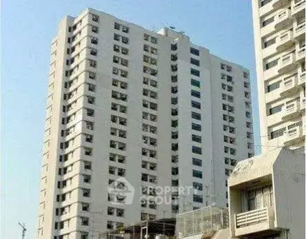 High-rise residential building with modern architecture and multiple balconies.
