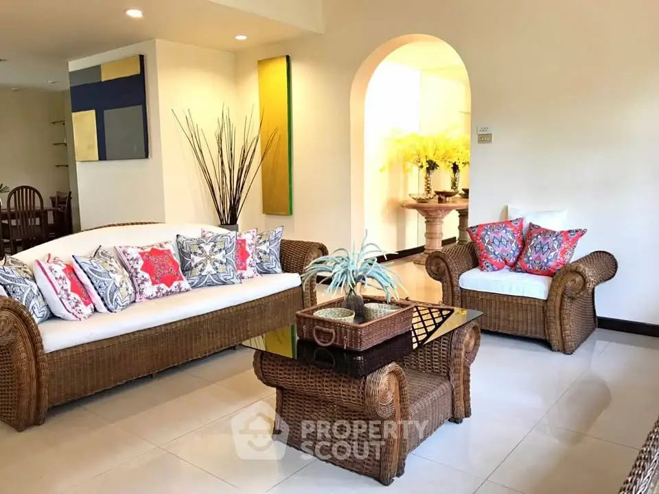 Charming living room with wicker furniture and vibrant decor in a cozy home setting.