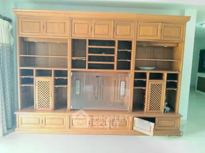 Spacious wooden entertainment center in a bright living room