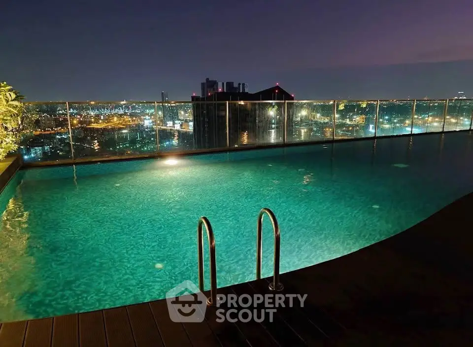 Luxurious rooftop pool with stunning city skyline view at night