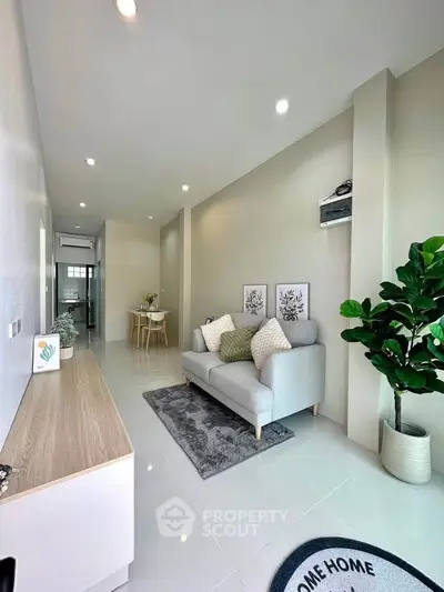 Modern living room with sleek furniture and stylish decor in a bright, open space.