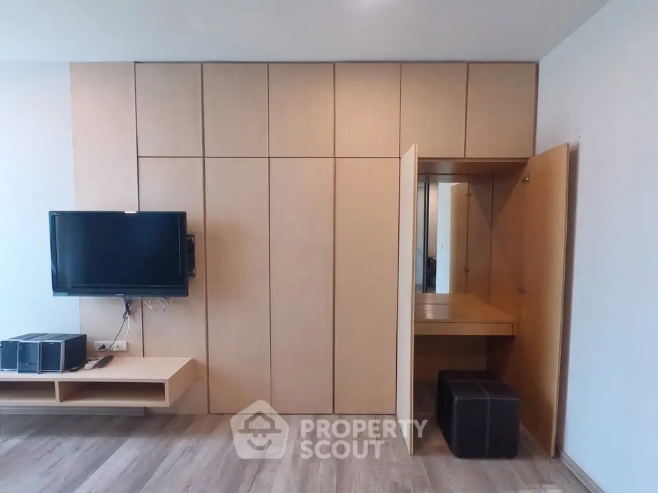 Modern living room with sleek wooden paneling and wall-mounted TV