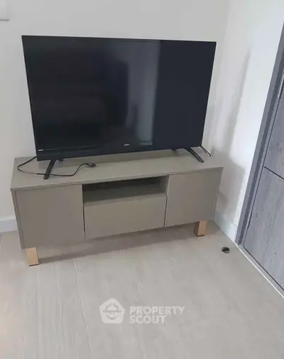 Modern living room with sleek TV stand and flat-screen television, perfect for entertainment setup.