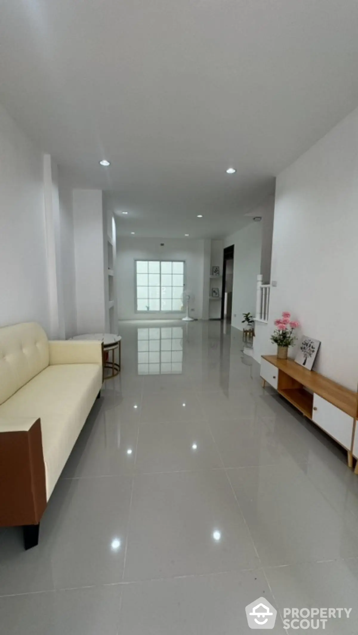 Spacious modern living room with sleek tile flooring and minimalist decor