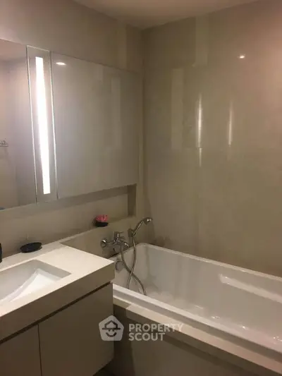 Modern bathroom with sleek design and built-in bathtub, perfect for relaxation.