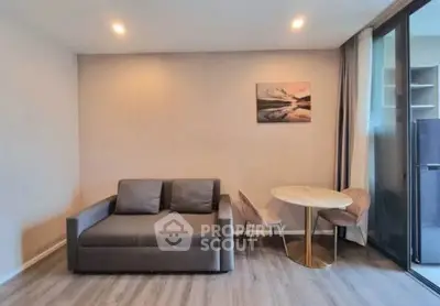 Modern living room with stylish sofa and dining area in a cozy apartment.