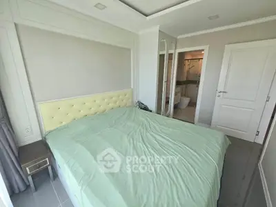 Spacious bedroom with ensuite bathroom in modern apartment