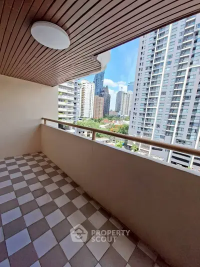 Spacious balcony with city view in modern high-rise building, perfect for urban living.