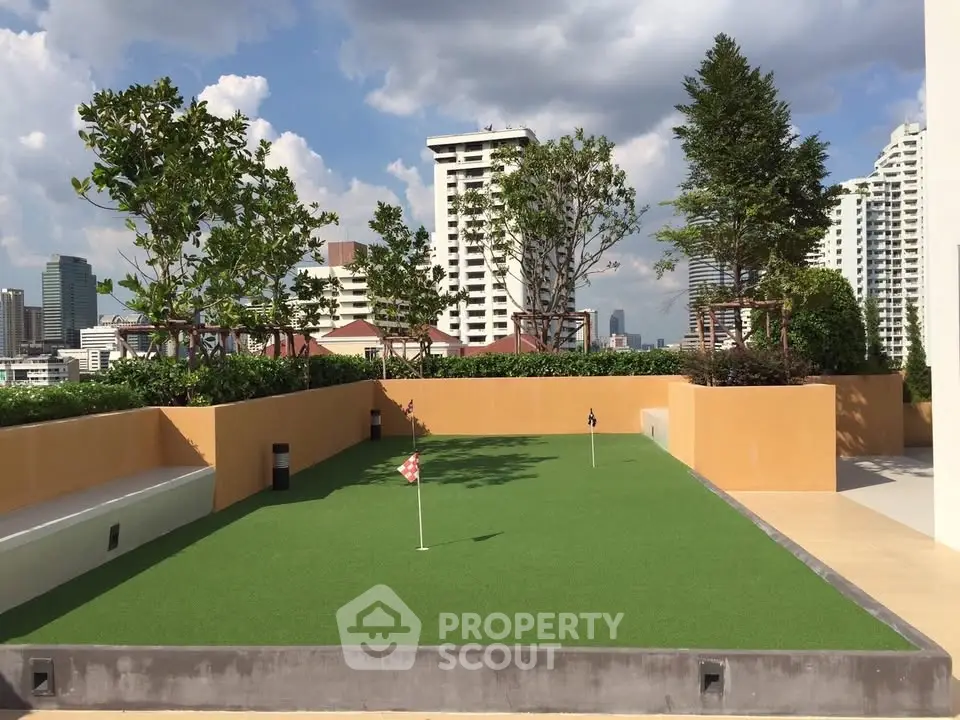 Luxurious rooftop garden with putting green and stunning city skyline views.