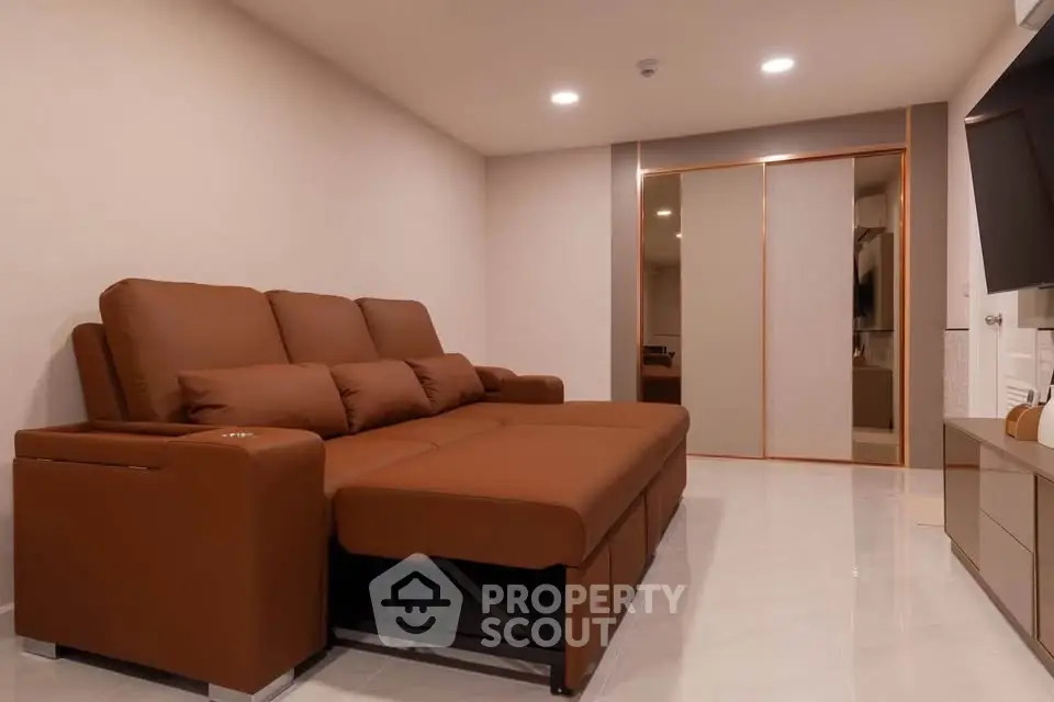 Spacious living room with modern brown sofa and sleek decor