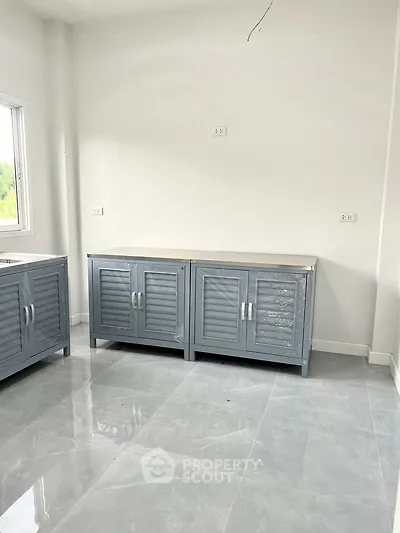 Modern kitchen with sleek cabinets and glossy tile flooring