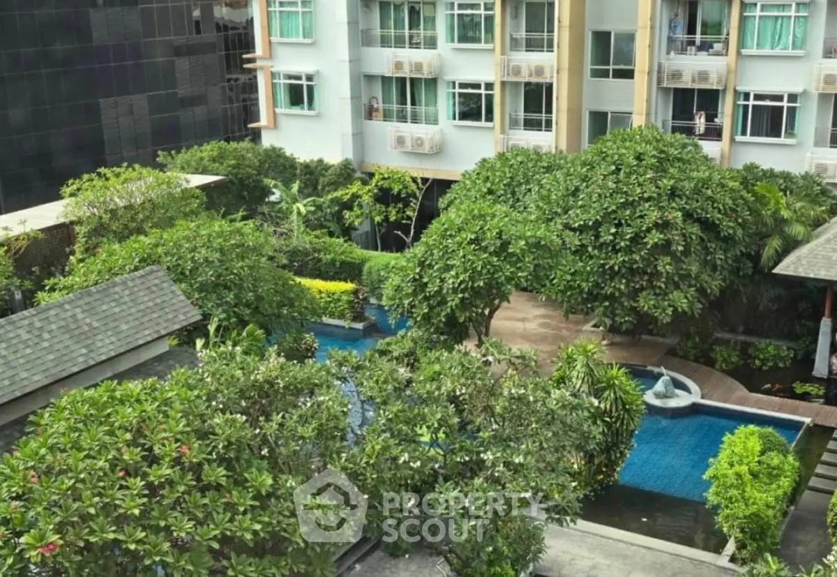 Lush garden view with pool in modern residential complex