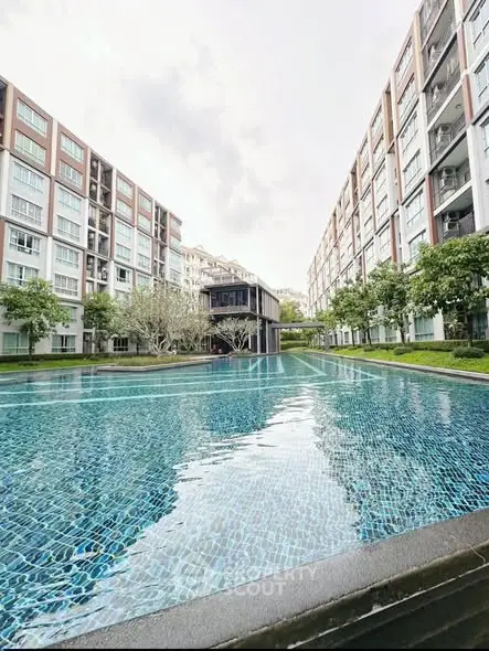 Luxurious residential complex with a stunning outdoor pool and modern architecture.