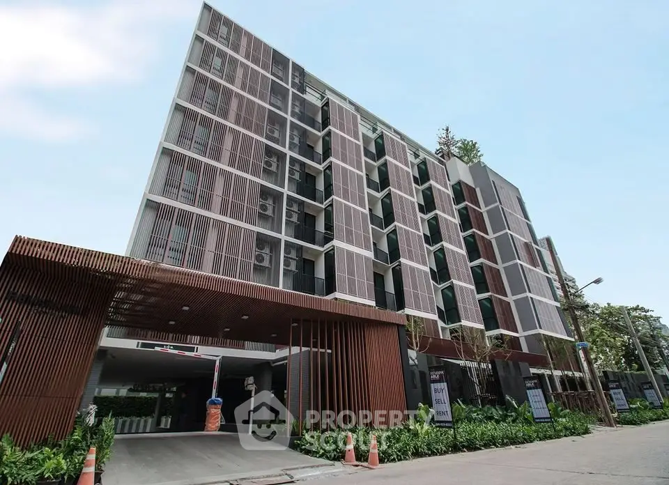 Modern apartment building with unique facade and lush greenery