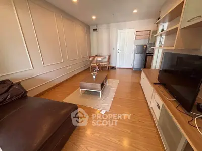 Modern living room with stylish furniture and open layout, featuring a cozy seating area and dining space.