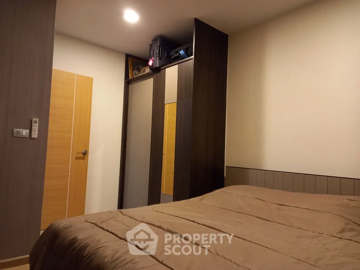 Cozy bedroom with modern wardrobe and warm lighting